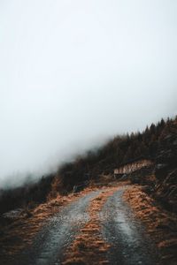Preview wallpaper road, slope, trees, building, cloud