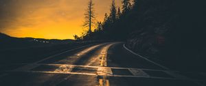 Preview wallpaper road, slope, turn, sunset, twilight, glow, asphalt, road marking