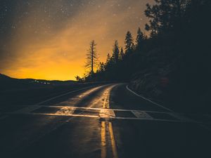 Preview wallpaper road, slope, turn, sunset, twilight, glow, asphalt, road marking