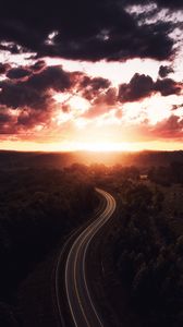 Preview wallpaper road, sunset, sky, trees, forest, aerial view