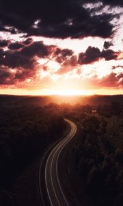 Preview wallpaper road, sunset, sky, trees, forest, aerial view