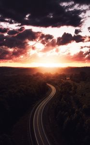 Preview wallpaper road, sunset, sky, trees, forest, aerial view