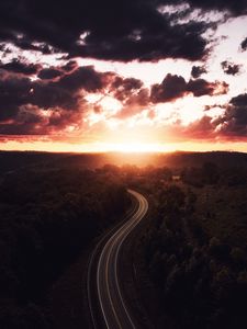 Preview wallpaper road, sunset, sky, trees, forest, aerial view