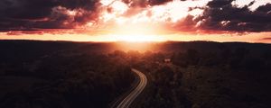 Preview wallpaper road, sunset, sky, trees, forest, aerial view