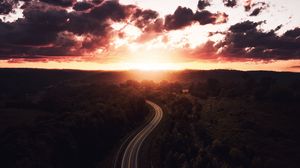 Preview wallpaper road, sunset, sky, trees, forest, aerial view