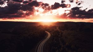 Preview wallpaper road, sunset, sky, trees, forest, aerial view