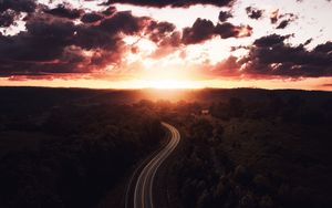 Preview wallpaper road, sunset, sky, trees, forest, aerial view