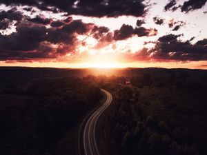 Preview wallpaper road, sunset, sky, trees, forest, aerial view