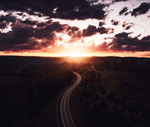 Preview wallpaper road, sunset, sky, trees, forest, aerial view