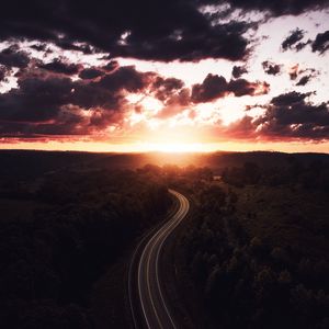 Preview wallpaper road, sunset, sky, trees, forest, aerial view