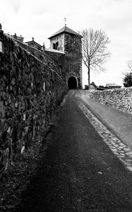 Preview wallpaper road, tower, wall, black and white