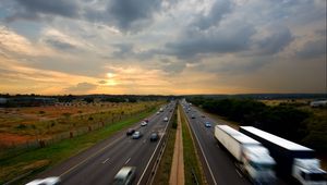 Preview wallpaper road, traffic, cars, sky, sunset