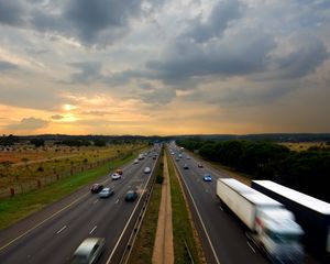 Preview wallpaper road, traffic, cars, sky, sunset