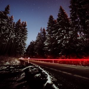 Preview wallpaper road, trees, night, snow, long exposure