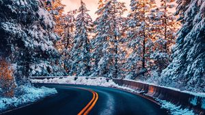 Preview wallpaper road, trees, snow, sunset, turn