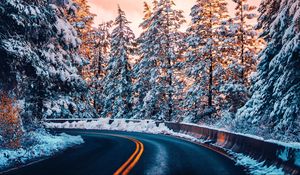 Preview wallpaper road, trees, snow, sunset, turn