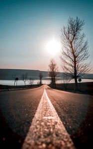 Preview wallpaper road, trees, sunset, sky, direction