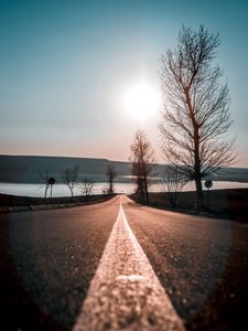 Preview wallpaper road, trees, sunset, sky, direction