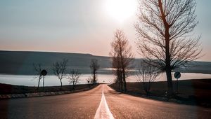 Preview wallpaper road, trees, sunset, sky, direction