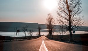 Preview wallpaper road, trees, sunset, sky, direction