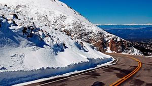 Preview wallpaper road, turn, lines, yellow, asphalt, mountains, snow