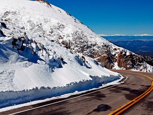 Preview wallpaper road, turn, lines, yellow, asphalt, mountains, snow