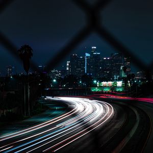 Preview wallpaper road, turn, night city, buildings, lights, long exposure