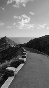 Preview wallpaper road, turn, rocks, mountains, black and white