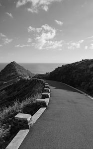 Preview wallpaper road, turn, rocks, mountains, black and white