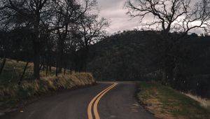 Preview wallpaper road, turn, stripes, trees, hills, nature