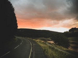 Preview wallpaper road, turn, sunset, trees, sky, clouds