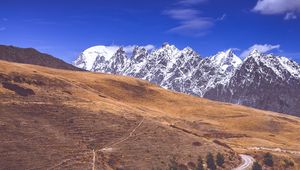 Preview wallpaper road, winding, mountains, snowy, slope