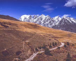 Preview wallpaper road, winding, mountains, snowy, slope