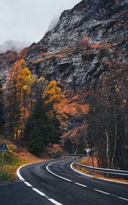 Preview wallpaper road, winding, rocks, marking, fog