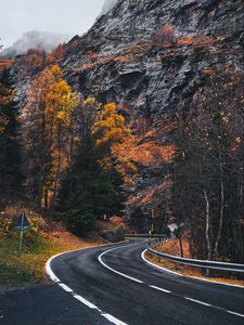 Preview wallpaper road, winding, rocks, marking, fog