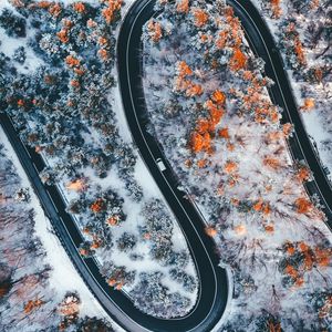 Preview wallpaper road, winding, trees, snow, panorama, aerial view, zigzag