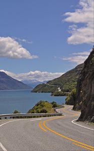 Preview wallpaper road, zigzag, rocks, sea, landscape