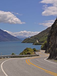 Preview wallpaper road, zigzag, rocks, sea, landscape