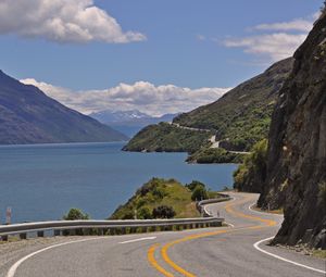 Preview wallpaper road, zigzag, rocks, sea, landscape