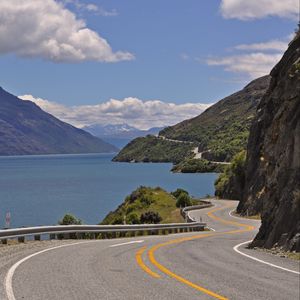 Preview wallpaper road, zigzag, rocks, sea, landscape