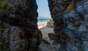 Preview wallpaper rock, arch, beach, man, sea, nature