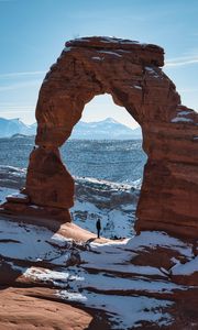Preview wallpaper rock, arch, man, alone, snow, nature