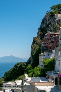 Preview wallpaper rock, buildings, houses, sea, mountain