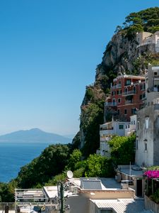 Preview wallpaper rock, buildings, houses, sea, mountain