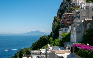 Preview wallpaper rock, buildings, houses, sea, mountain