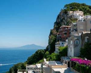 Preview wallpaper rock, buildings, houses, sea, mountain