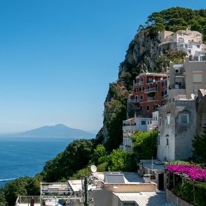 Preview wallpaper rock, buildings, houses, sea, mountain