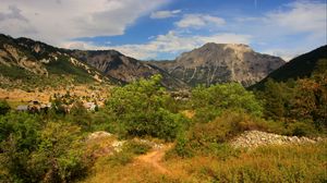 Preview wallpaper rock, bushes, grass, peak, sky