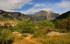 Preview wallpaper rock, bushes, grass, peak, sky