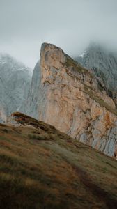 Preview wallpaper rock, cliff, fog, slope, mountains